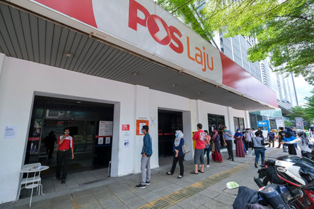 KUALA LUMPUR, MALAYSIA - MAY 04, 2020: People wearing a face mask while lining up with social distancing at the post office. Malaysia Coronavirus disease 2019 (COVID-19) outbreak.のeditorial素材
