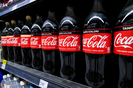 KUALA LUMPUR, MALAYSIA - MAY 04, 2020: Coca Cola product in bottles on the shelves in a grocery store supermarket. Coke is a carbonated soft drink produced by The Coca-Cola Company.のeditorial素材