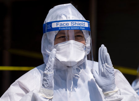 KUALA LUMPUR, MALAYSIA - MAY 15, 2020: Government health worker wearing a protective suit prepares...