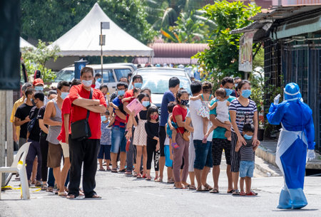 KUALA LUMPUR, MALAYSIA - MAY 15, 2020: Foreign migrant workers and their family wearing a face mask...