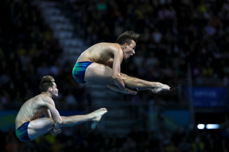 GOLD COAST, AUSTRALIA - APRIL 13, 2018: Domonic Bedggood and Matthew Carter of Australia compete in the Men's Synchronised 3m Springboard Diving Final of the Gold Coast 2018 Commonwealth Games.のeditorial素材