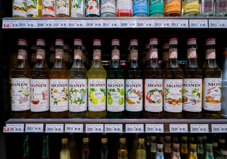 KUALA LUMPUR, MALAYSIA - FEBRUARY 05, 2022: Bottles of various flavours of Monin syrup on the shelf in a supermarket. Monin is a French company that makes syrup, liqueur and fruit purのeditorial素材
