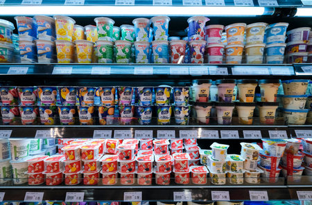 KUALA LUMPUR, MALAYSIA - FEBRUARY 05, 2022: Various brands of yogurt on the shelf in a grocery store. Yogurt also spelled yoghurt or yogourt is a food produced by bacterial fermentation of milk.のeditorial素材