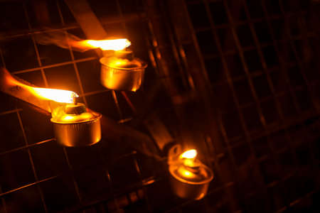 Malay tradition kerosene oil lamp or pelita selective focus during Hari Raya Aidilfitri celebration. Muslim Eidul fitri concept. Image contains noise and soft focus.の写真素材