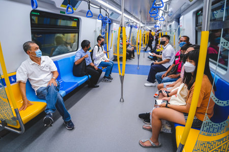 KUALA LUMPUR, MALAYSIA - MARCH 16, 2023: Passenger inside Mass Rapid Transit (MRT) Putrajaya Line train. MRT alleviate the severe traffic congestion in the KL metropolitan area.のeditorial素材