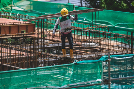 KUALA LUMPUR, MALAYSIA - MARCH 28, 2023: Construction workers wearing safety protective equipment...