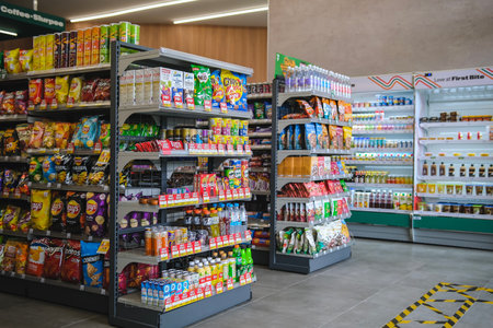 KUALA LUMPUR, MALAYSIA - MAY 22, 2023: Variety of snacks, chips, soft drinks and candy on the...