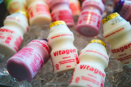 KUALA LUMPUR, MALAYSIA - JUNE 22, 2023: Vitagen bottles in a cold ice tray. Vitagen is a probiotic beverage cultured milk and good for a healthy digestive system.のeditorial素材