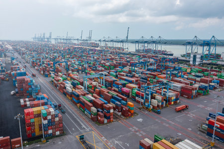KLANG, MALAYSIA - OCTOBER 27, 2023:  International import-export containers cargo ship at Westports, Port Klang. Westports serves as the main gateway for container and conventional cargo.のeditorial素材