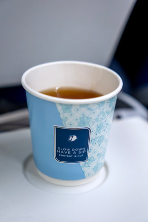 KUALA LUMPUR, MALAYSIA - SEPTEMBER 17, 2023: Hot tea drink served in Malaysia Airlines flight. Malaysia Airlines is proud to carry the flag as Malaysia's national carrier.のeditorial素材