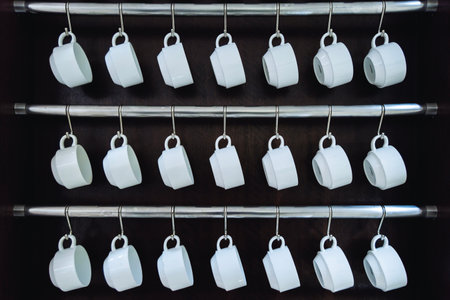 Rows of many empty white cups for coffee or tea in seminar event or meeting room. Drinkware.の写真素材