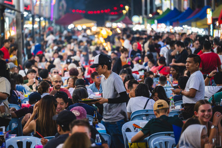 KUALA LUMPUR, MALAYSIA - DECEMBER 27, 2025: Tourists and locals enjoy evening street dining along...