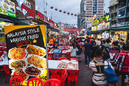KUALA LUMPUR, MALAYSIA - DECEMBER 27, 2025: Tourists and locals enjoy evening street dining along...