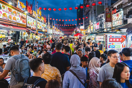 KUALA LUMPUR, MALAYSIA - DECEMBER 27, 2025: Tourists and locals enjoy evening street dining along...