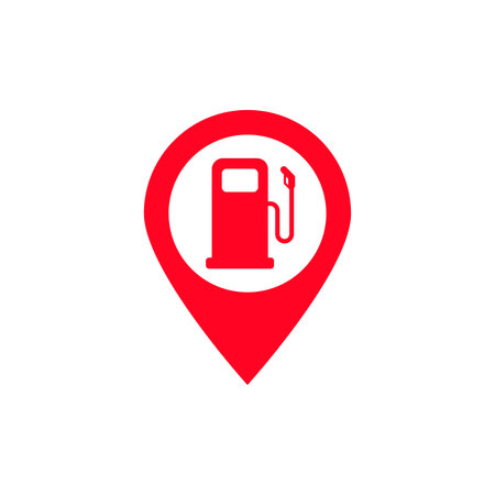 The image depicts a red map pin with a white background, featuring a red gas pump icon in the center. This symbol is commonly used to indicate the location of a gas station on maps or navigation apps.の写真素材