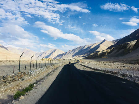 Long ride along the mountain range with blue sky and white clouds.のeditorial素材