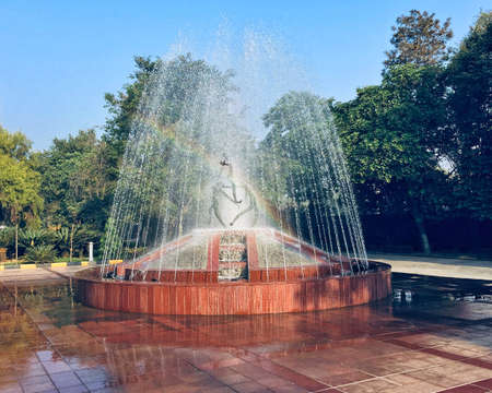 This is a shot of a rainbow that appears from the refraction of early morning sunlight inside a fountain.のeditorial素材