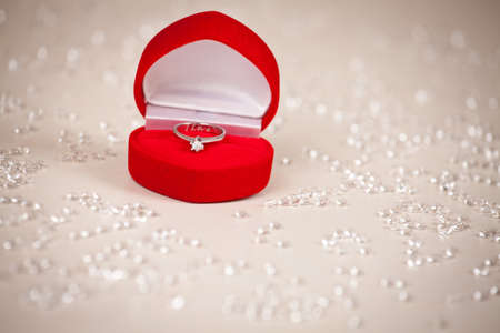 Diamond ring in heart shaped, red jewel box.の写真素材