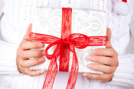Man holding a gift box in his hand の写真素材