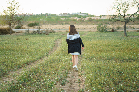Enjoying the nature Young beautiful girl enjoying the fresh air in green meadow. sunny sumer / spring day.の写真素材