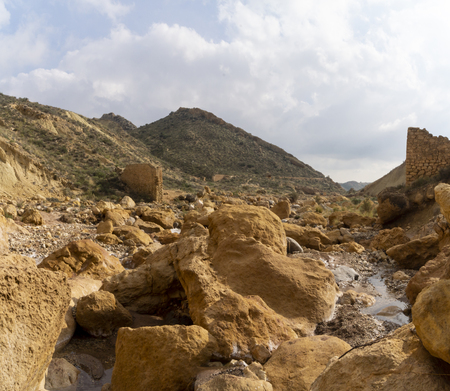 Beautiful landscape of dried salty mountain river with clouds in the sky at La Rambla, La Murada, Orihuela, Spain Mountain area with small river extremely dry and salty. the water created a unique and desert environmentの写真素材
