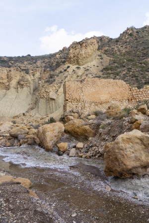 Beautiful landscape of dried salty mountain river with clouds in the sky at La Rambla, La Murada, Orihuela, Spain. Mountain area with small river extremely dry and salty. the water created a unique and desert environmentの写真素材