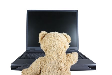 Teddy-Bear in Front of Laptop - Symbolic for Youth, Childhood, Security, Dangersの写真素材