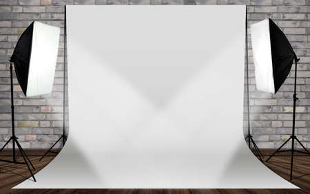 photo studio with a lamp and canvas in front of a brick wallの写真素材