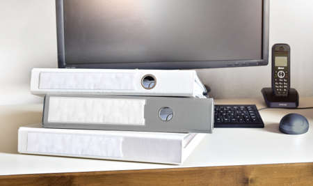 office desk with folders on it and telephone