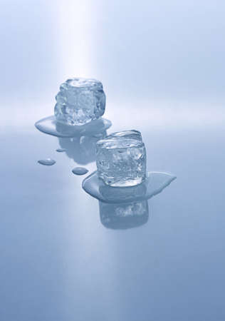 Two blue colored ice cubes melted in water