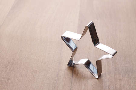 Baking tin star shape on a wooden background