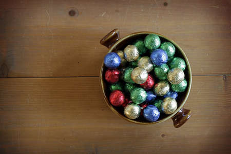Colorful Chocolate balls in a bowl with space for textの写真素材