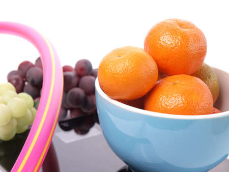 Orange fruits on a scale with grapes of wine  の写真素材