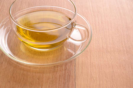 Cup of green tea on a wooden backgroundの写真素材