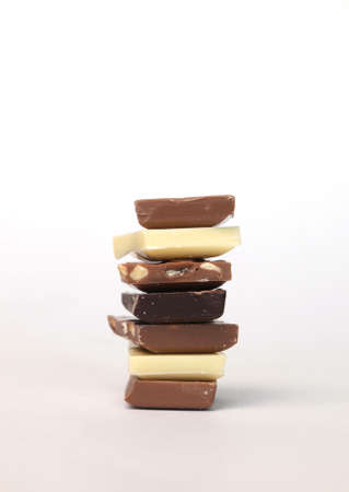 Different chocolate pieces on a bright backgroundの写真素材
