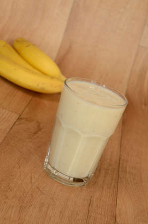 Shake of fresh bananas on a wooden backgroundの写真素材