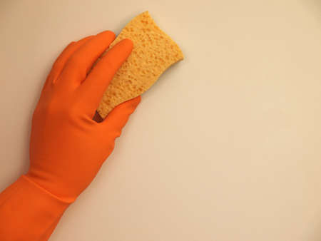 Hand with a rubber glove cleaning a surfaceの写真素材