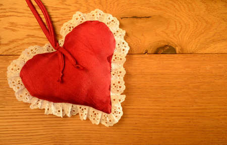 Red heart shape on a wooden backgroundの写真素材
