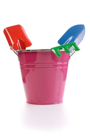 Gardening tools in a violet bucket on a white backgroundの写真素材