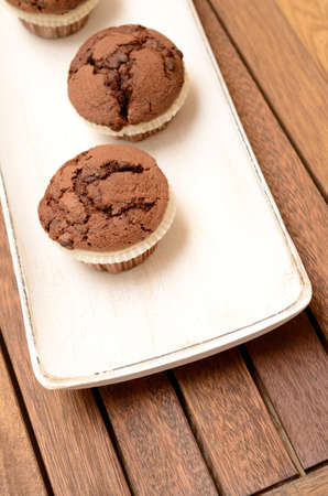 Sweet muffins on a white wooden bowlの写真素材