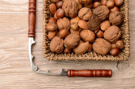 Nuts mix in a basket with a nutcrackerの写真素材