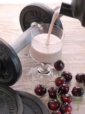 Healthy shake drink with dumbbellsの写真素材