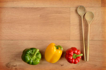 Colorful paprika on a wooden background with space for textの写真素材