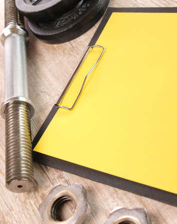 Notebook with a red letter and sports equipment