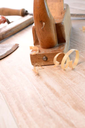 Old used carpenter tools on a wooden 