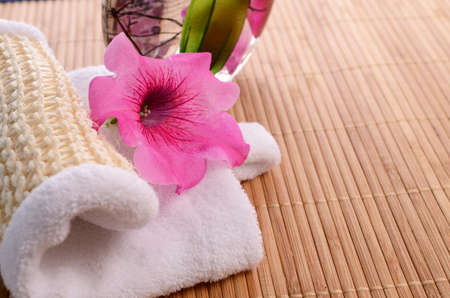 Bath additive with a towel and flower decoration