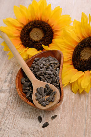 Sunflower seeds in a wooden bowlの写真素材