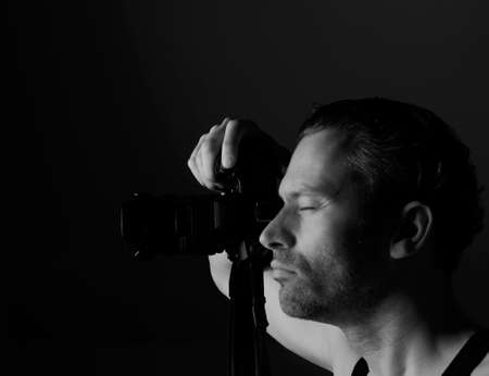 Photographer on a dark backgroundの写真素材