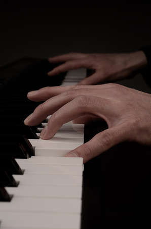 Close up of hands playing piano