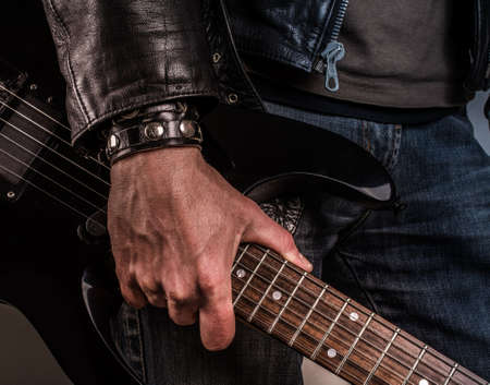 Rock star with an old scratched guitarの写真素材